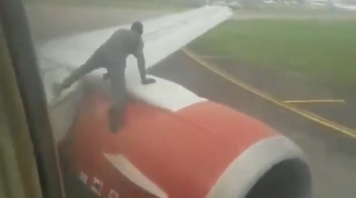 Man klimt op vleugel Nigeriaans vliegtuig